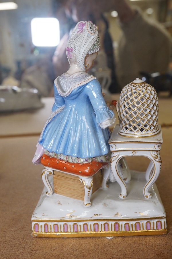 A late 19th century Meissen porcelain figure, ‘Sentiment’ modelled as a young woman seated with a parrot in a gilded cage, 15cm high. Condition - fair, chipping